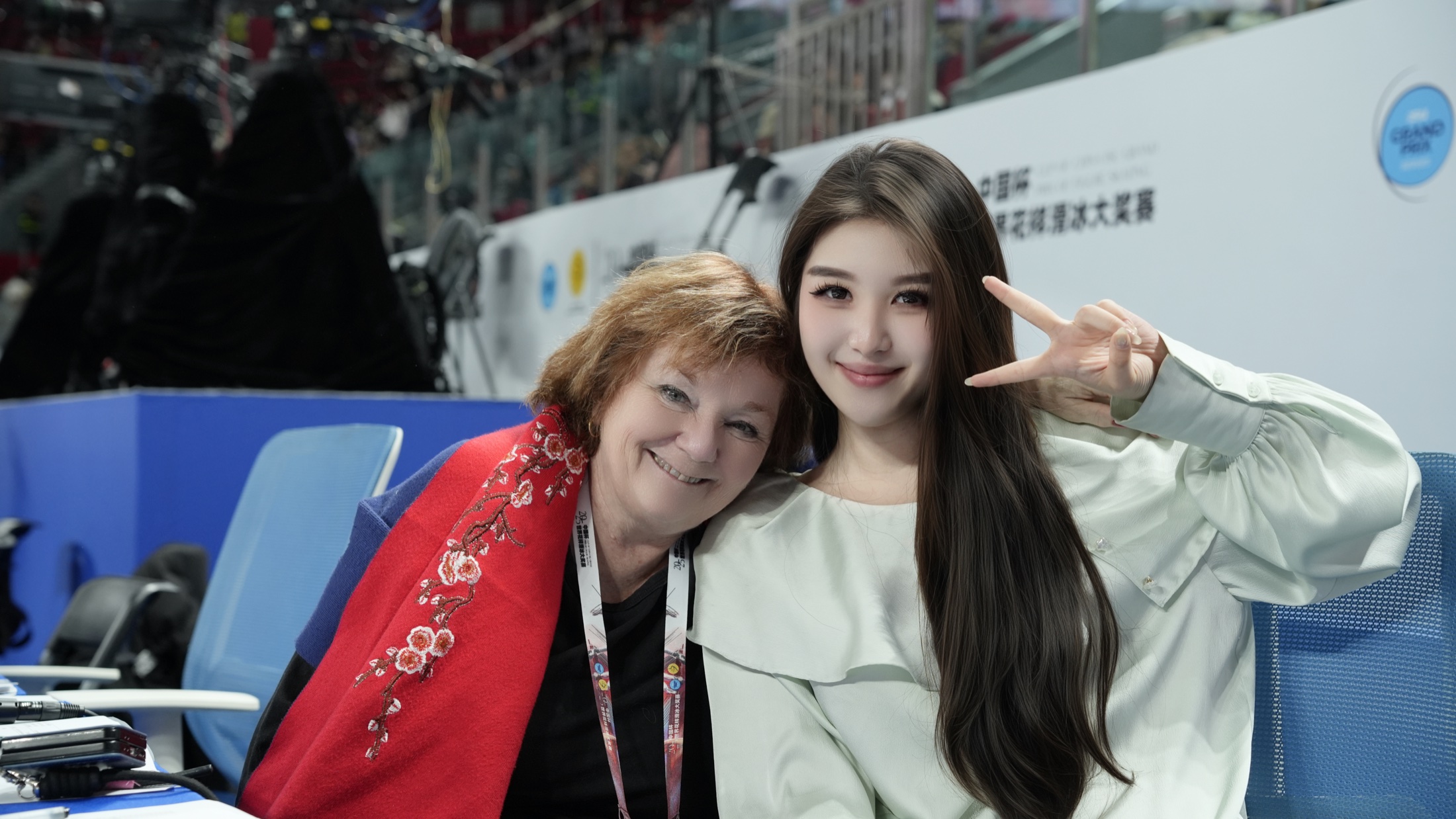 Yiwen Zhang with a colleague at the competition announcing desk